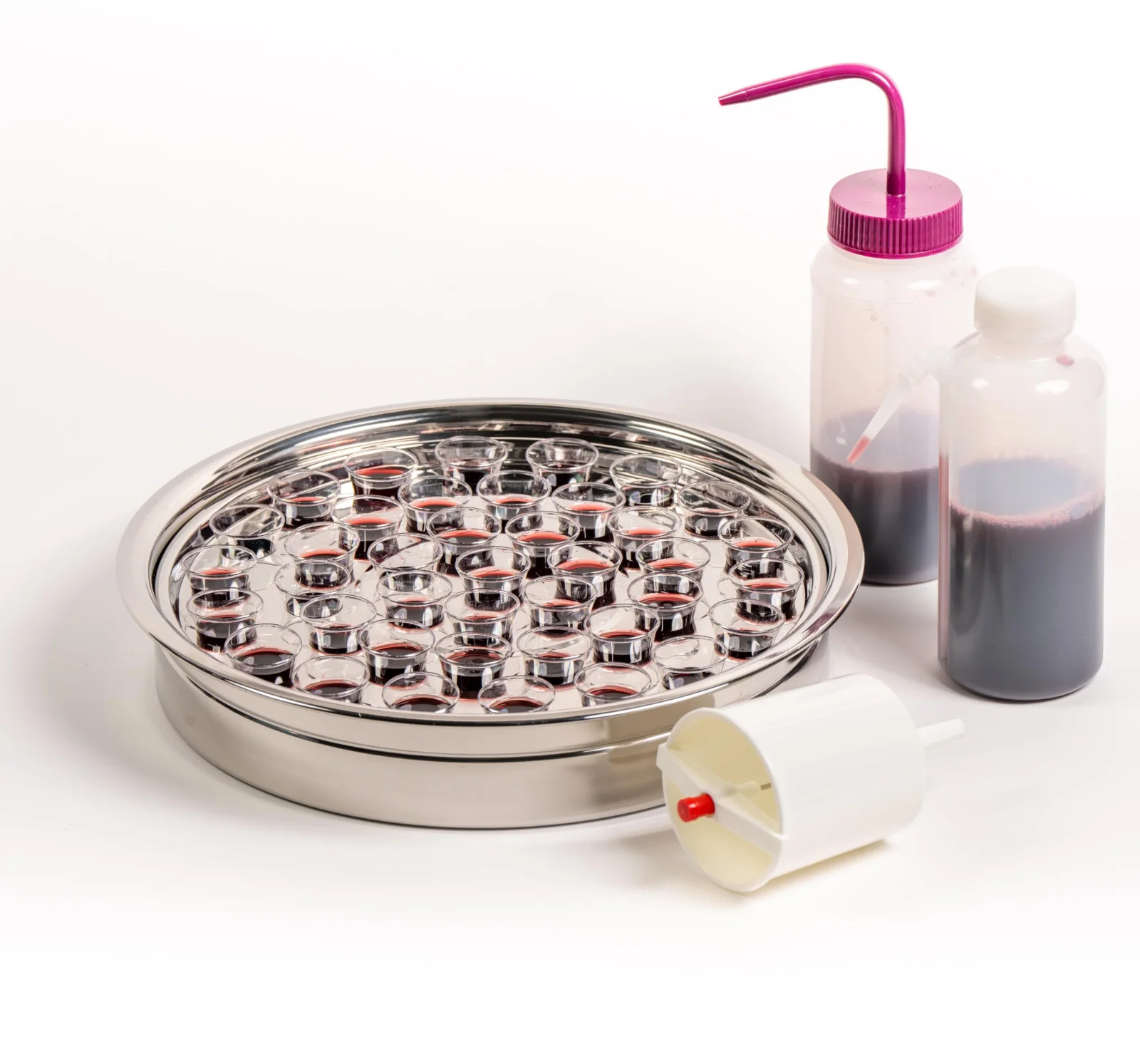 Filler bottles beside a silver tray of empty cups